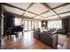 Inviting living room with coffered ceilings, hardwood floors, and a wall of windows at 13599 Brentwood Ln, Carmel, IN 46033