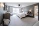 Bright and airy main bedroom with decorative wall, ensuite bathroom, and large window at 13599 Brentwood Ln, Carmel, IN 46033