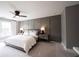 Spacious main bedroom featuring modern gray wall accents, carpet, and a ceiling fan at 13599 Brentwood Ln, Carmel, IN 46033