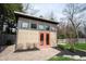 Modern shed with eye-catching orange doors, multiple windows, and landscaping at 13599 Brentwood Ln, Carmel, IN 46033
