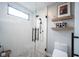 Modern shower with glass enclosure and sleek fixtures, plus a window and stylish tile at 13599 Brentwood Ln, Carmel, IN 46033