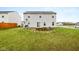 Backyard with a grassy area and a small patio with a built-in feature at 13820 N Cardonia Dr, Camby, IN 46113