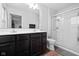 Modern bathroom with a double vanity, dark wood cabinets, and a glass-enclosed shower at 13820 N Cardonia Dr, Camby, IN 46113