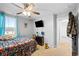 Bedroom with large windows, neutral carpet, ceiling fan, and mounted television at 13820 N Cardonia Dr, Camby, IN 46113