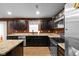 Stylish kitchen features granite countertops, stainless appliances, dark cabinets, and a view of the backyard at 13820 N Cardonia Dr, Camby, IN 46113