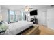 Spacious main bedroom featuring a tufted headboard, large windows, and a ceiling fan at 13820 N Cardonia Dr, Camby, IN 46113