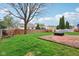 Spacious backyard featuring a brick patio and a well-maintained lawn at 13847 Wabash Dr, Fishers, IN 46038