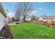 Large backyard with a brick fire pit, perfect for outdoor entertaining at 13847 Wabash Dr, Fishers, IN 46038