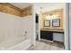 Bathroom featuring tiled walls, modern sink with dark vanity and bathtub at 13847 Wabash Dr, Fishers, IN 46038