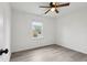 Bedroom features wood-look floors, a ceiling fan, and a bright window at 13847 Wabash Dr, Fishers, IN 46038