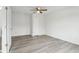 Bright bedroom with white walls, hardwood floor, ceiling fan, and door at 13847 Wabash Dr, Fishers, IN 46038