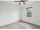 Bedroom featuring wood-look floors, a ceiling fan, and a bright window at 13847 Wabash Dr, Fishers, IN 46038