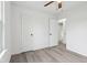 Bedroom features wood-look flooring, open closet, and ceiling fan at 13847 Wabash Dr, Fishers, IN 46038