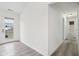 Bright hallway with wood-look floors leads to an updated bathroom and back door at 13847 Wabash Dr, Fishers, IN 46038