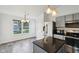 Modern kitchen features stainless steel appliances, gray cabinets, a kitchen island with barstool seating and pendant lighting at 13847 Wabash Dr, Fishers, IN 46038