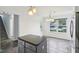 Eat in kitchen featuring stone floors, gray cabinets, stainless appliances, and stairs to the second floor at 13847 Wabash Dr, Fishers, IN 46038