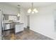 Bright eat-in kitchen with stainless appliances, stone floors, gray cabinets and kitchen island at 13847 Wabash Dr, Fishers, IN 46038