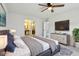 Staged main bedroom with ensuite bathroom, television, and ceiling fan at 13847 Wabash Dr, Fishers, IN 46038