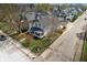 Aerial view of a charming home with a fenced yard and mature trees in a residential neighborhood at 1403 Fletcher Ave, Indianapolis, IN 46203