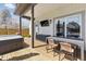 Inviting back deck with a hot tub, outdoor table and chairs, and mounted tv for outdoor entertaining at 1403 Fletcher Ave, Indianapolis, IN 46203