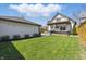 Spacious back yard with a well-maintained lawn, deck, hot tub, and detached garage at 1403 Fletcher Ave, Indianapolis, IN 46203