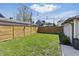 Large, grassy back yard with a privacy fence and string lights for outdoor enjoyment at 1403 Fletcher Ave, Indianapolis, IN 46203