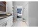 Bright bathroom with white cabinets, shelving, and a view of the ensuite bedroom at 1403 Fletcher Ave, Indianapolis, IN 46203