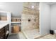 Modern walk-in shower featuring marble tiling and a neutral color palette at 1403 Fletcher Ave, Indianapolis, IN 46203