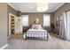 Neutral bedroom with a metal bed frame, closet, and light-filled windows at 1403 Fletcher Ave, Indianapolis, IN 46203