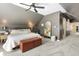 Bedroom featuring dark walls, sloped ceilings, neutral-toned carpet, a ceiling fan and a king-sized bed at 1403 Fletcher Ave, Indianapolis, IN 46203