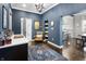 Formal dining room with blue walls, wood floors and connected to the kitchen area at 1403 Fletcher Ave, Indianapolis, IN 46203