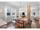 Bright dining area showcasing a stylish chandelier, exposed brick, and an open view to the living room at 1403 Fletcher Ave, Indianapolis, IN 46203