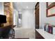 Hallway with brick accent wall and view of stairs at 1403 Fletcher Ave, Indianapolis, IN 46203