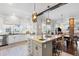 Beautiful kitchen with stainless steel appliances, white cabinets, gray island with bar seating, and an open concept design at 1403 Fletcher Ave, Indianapolis, IN 46203