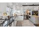 Bright kitchen featuring white cabinets, black countertops, stainless steel appliances, and an open concept design at 1403 Fletcher Ave, Indianapolis, IN 46203