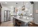 Bright kitchen featuring stainless steel appliances, white cabinets, and a large island with bar seating at 1403 Fletcher Ave, Indianapolis, IN 46203