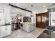 Spacious kitchen with open layout featuring stainless steel appliances, light gray island, and vintage china cabinet at 1403 Fletcher Ave, Indianapolis, IN 46203