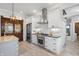 Kitchen featuring stainless steel appliances, gas range and hood, white cabinetry, and black countertops at 1403 Fletcher Ave, Indianapolis, IN 46203