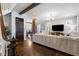 Bright living room showcasing hardwood floors, exposed wood beams, and a stylish staircase at 1403 Fletcher Ave, Indianapolis, IN 46203