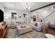 Spacious living room featuring a sectional sofa, ottoman, and stylish decor, perfect for entertaining guests at 1403 Fletcher Ave, Indianapolis, IN 46203