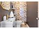 Stylish powder room with modern sink, gold hardware, and patterned wallpaper at 1403 Fletcher Ave, Indianapolis, IN 46203