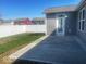 Large concrete patio in backyard with vinyl fence and low-maintenance landscaping at 1468 Lexington Trl, Greenfield, IN 46140