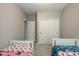 ' bedroom features twin beds and closet doors, and neutral walls and carpet at 1468 Lexington Trl, Greenfield, IN 46140