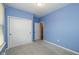 Brightly painted bedroom features closet doors, carpet, and a large window at 1468 Lexington Trl, Greenfield, IN 46140