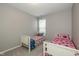 ' bedroom featuring two twin beds, a window and light gray walls and carpet at 1468 Lexington Trl, Greenfield, IN 46140
