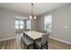 Cozy dining area with a modern table, bench seating, pendant lighting, and hardwood flooring at 1468 Lexington Trl, Greenfield, IN 46140