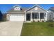 Charming single-Gathering home with a two-car garage, well-manicured lawn and a brick and vinyl facade at 1468 Lexington Trl, Greenfield, IN 46140