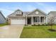 Charming single-Gathering home with a brick and gray facade, attached two-car garage, and a well-maintained lawn at 1468 Lexington Trl, Greenfield, IN 46140
