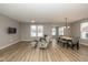 Open-concept living room featuring wood floors, recessed lighting, and seating area with decorative patterned chair at 1468 Lexington Trl, Greenfield, IN 46140