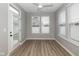 Bright sunroom with hardwood flooring, recessed lighting, and multiple large windows for natural light at 1468 Lexington Trl, Greenfield, IN 46140
